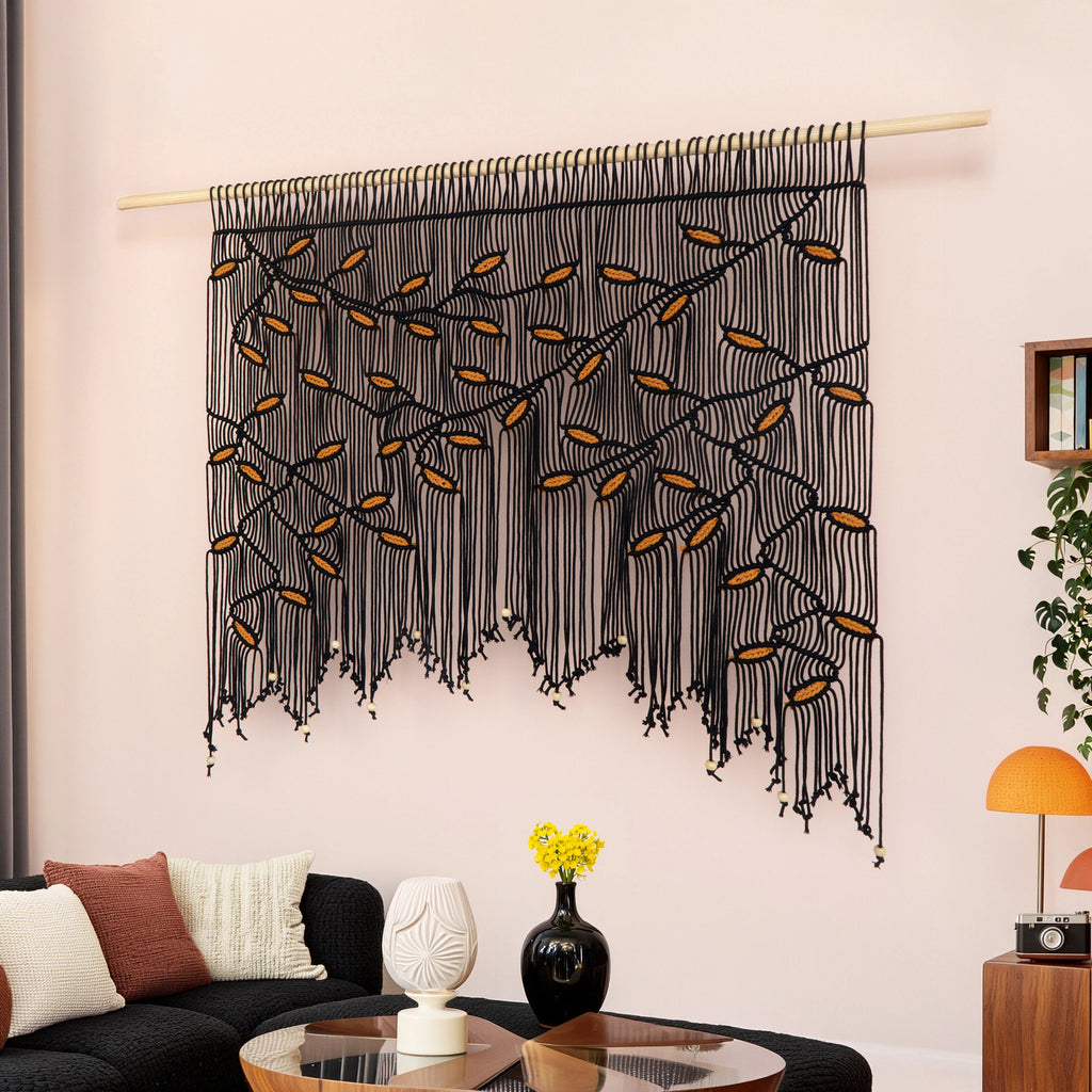 Artisanal black fiber art piece designed with dense multi-layered knotwork to add acoustic texture and bold modern contrast to interiors.