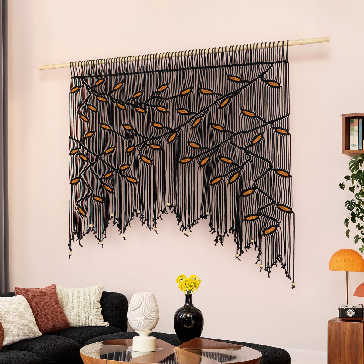 Artisanal black fiber art piece designed with dense multi-layered knotwork to add acoustic texture and bold modern contrast to interiors.