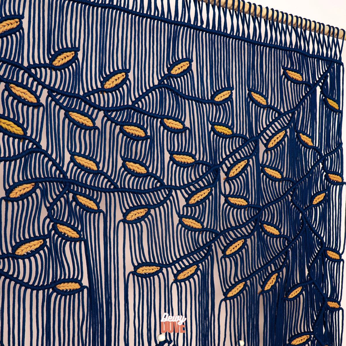 Oversized navy and ochre macrame hanging designed to anchor open-concept living spaces with rich tactile depth and vibrant color.
