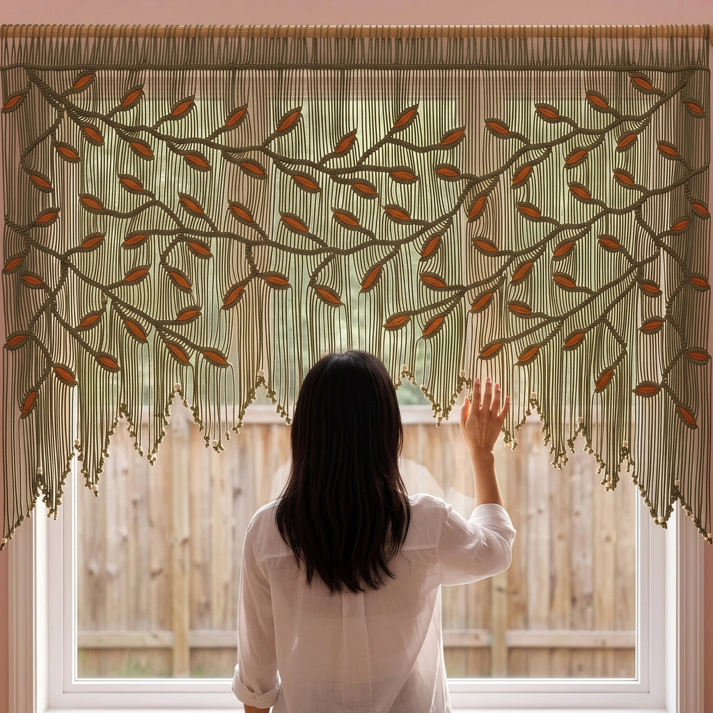 Hand-knotted 100% cotton rope wall hanging in deep olive green with vibrant orange leaf details and a natural wooden hanging rod.