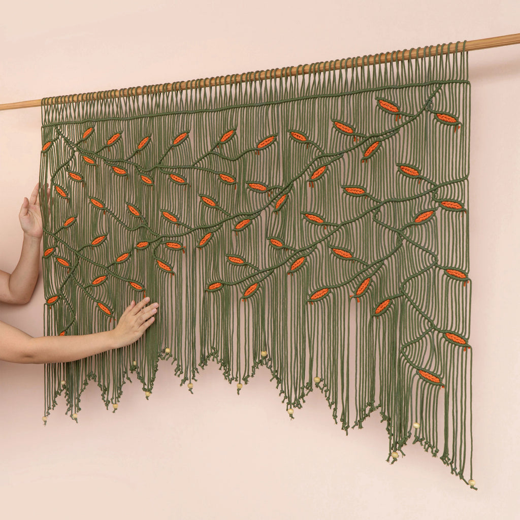 Modern boho olive green macrame tapestry designed with warm earth tones, ideal for living room focal walls and bedroom headboards.