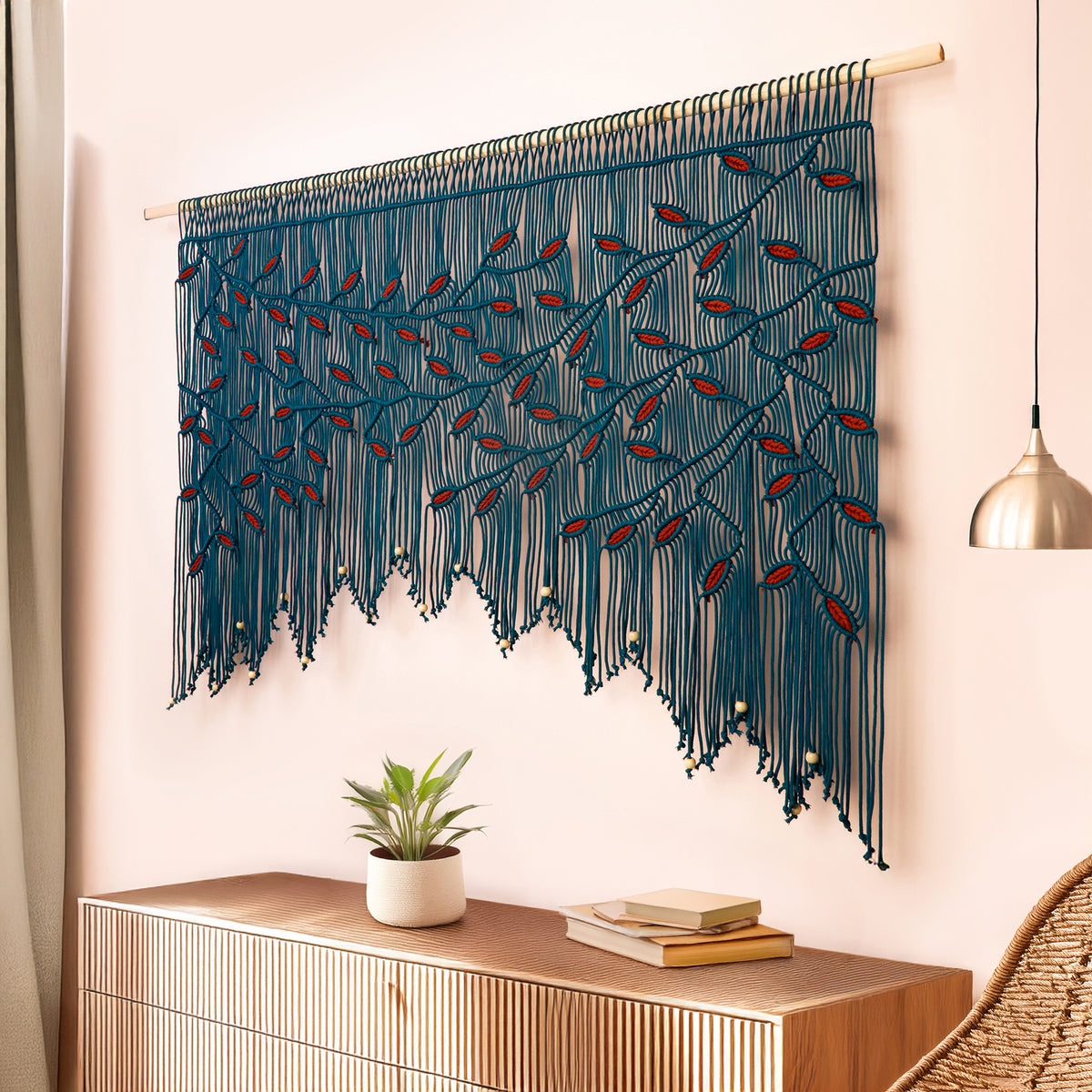 Artisan fiber art in dark peacock with meticulous burgundy leaf knotting on a natural wood dowel.