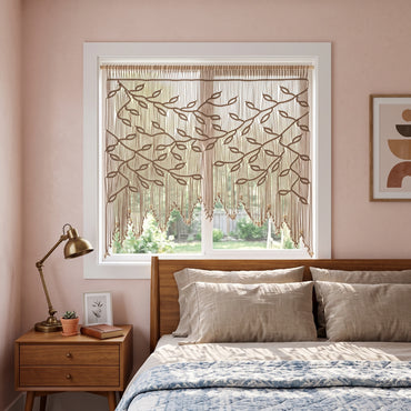 Living room with pink walls, a window with decorative blinds, a piano, and a green armchair.